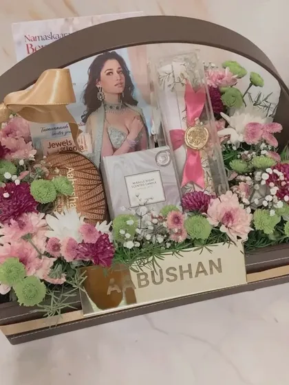 We design premium PR and invite hampers that make a lasting impression. This custom basket for Aabushan jewellers features fresh flowers, branded materials, and elegant scroll invites to create an unforgettable unboxing experience for influencers and guests.