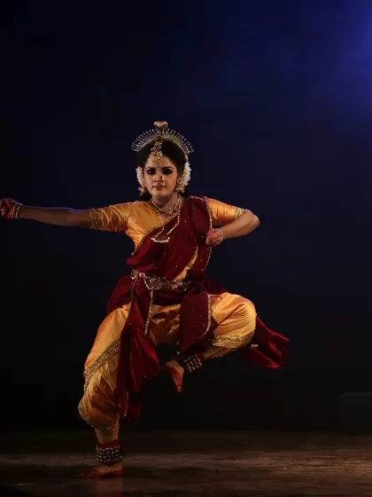 A solo performer captured in a moment of intense expression during "Shrishti Stithi Laya". The dramatic lighting and powerful posture convey the raw emotion of the story.