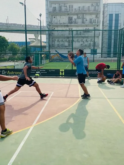 A player looks to pass to a cutting teammate. We teach the importance of court vision and making the right pass.