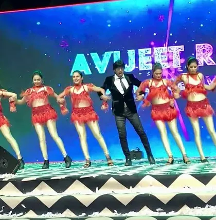 A full-stage view of our performance at the Surat wedding. The scale of the stage and my team of dancers in red create a stunning visual.