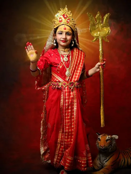 A full-length shot showing the complete Devi look, with the trishul and tiger. Celebrating Navratri by dressing up our betis is a beautiful way to honor the divine feminine.