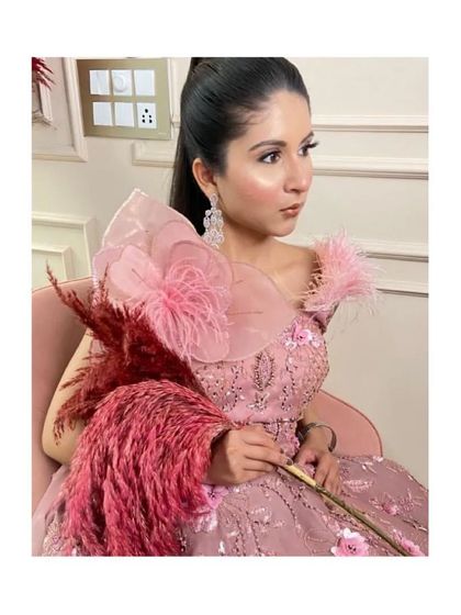 This pink gown is perfect for making a statement. The unique shoulder design and sequin work are sure to turn heads.