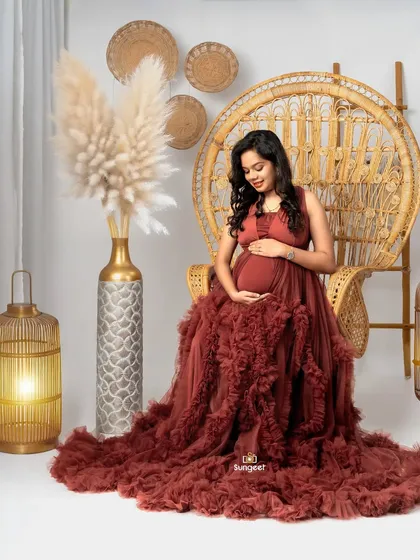 A solo portrait of the mom-to-be seated in the peacock chair.