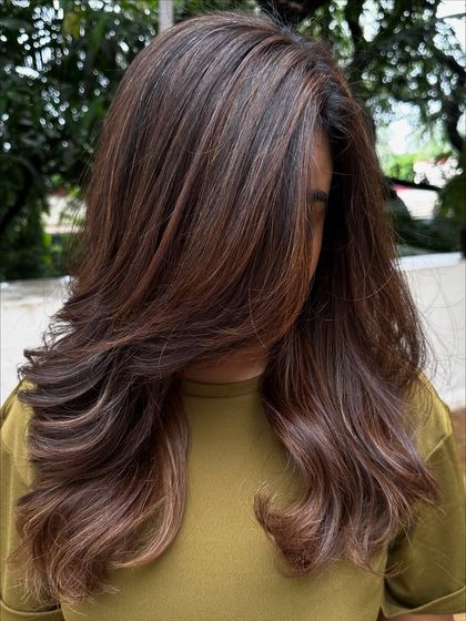 Getting her 'Vacay Hair' on with these beautiful ribbon highlights. This technique creates a gorgeous, flowing look that’s perfect for showing off on your next trip.