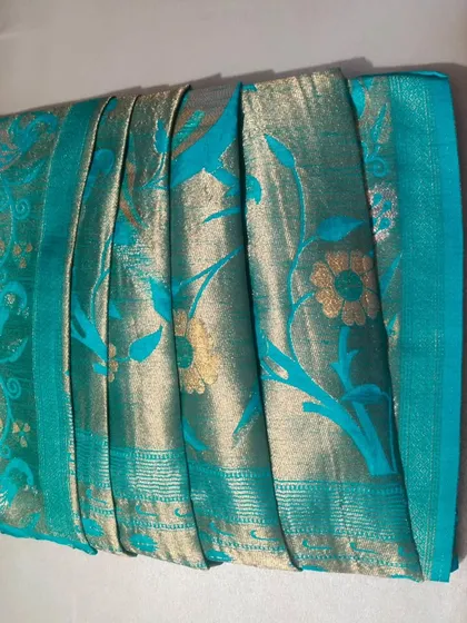 Another angle of the pre-pleated and box-folded Gujarati style saree. This view shows the neatness of the pleats before they are draped.