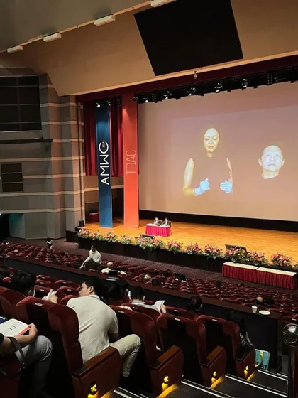 A view from the audience at one of my live demonstrations. Teaching and sharing my techniques with fellow dermatologists is a core part of my mission to elevate the field of aesthetics.