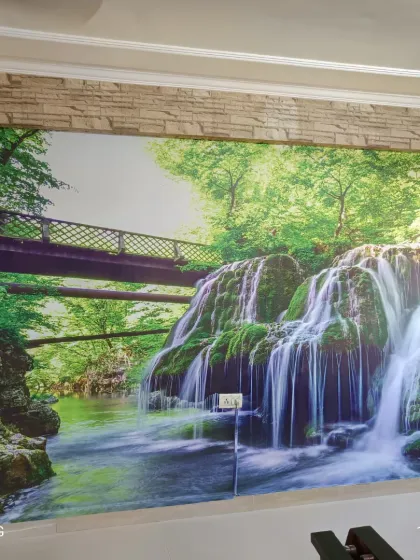 A hyper-realistic waterfall mural that brings the power and beauty of nature indoors. This kind of scenic wallpaper can make a room feel larger and more open.