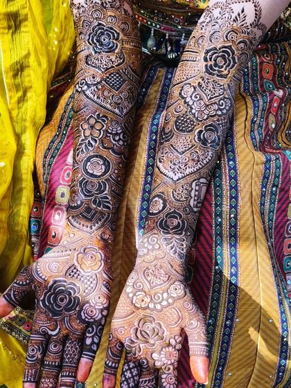 The beautiful mehndi for bride Saba, captured from different angles. The design includes personalized initials and a rich, dark stain.