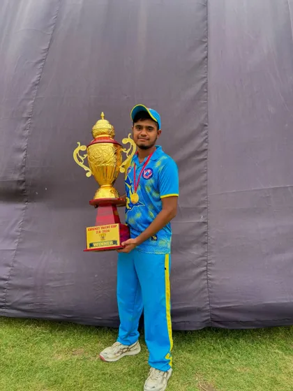 A senior player from the winning team with the trophy.