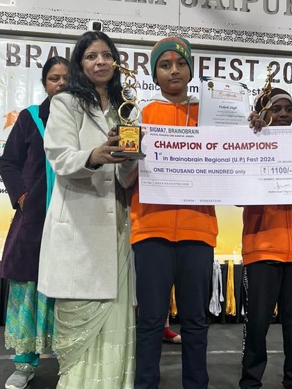 I am always proud to present awards to our champions. Here, a student receives his "Champion of Champions" trophy and prize, a recognition of his outstanding performance.