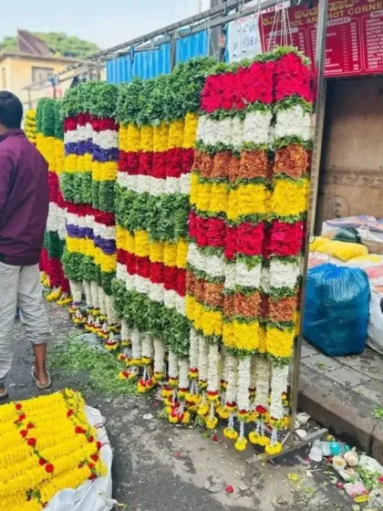 Our team preparing long, colorful flower strings for a large event decoration. We ensure all our floral products are fresh and neatly arranged.