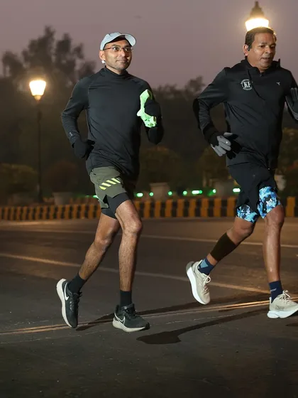 Two athletes running side-by-side, a perfect example of the camaraderie in our group.