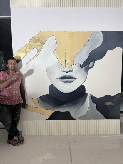 A moment of relaxation after finishing this powerful abstract portrait. The face, partially obscured by gold and grey shapes, creates a mysterious and modern piece of art.