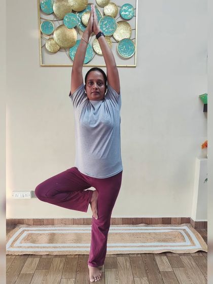 A student holds Vrikshasana (Tree Pose), a wonderful asana for improving balance, focus, and strengthening the leg muscles.