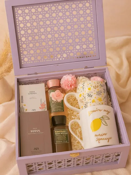 This 'His & Hers' hamper is perfect for newlyweds or as an anniversary gift. It features matching floral and "main squeeze" mugs, along with mini perfumes and shower gels from Zara and Bath & Body Works, all presented in a beautiful lilac cane box.