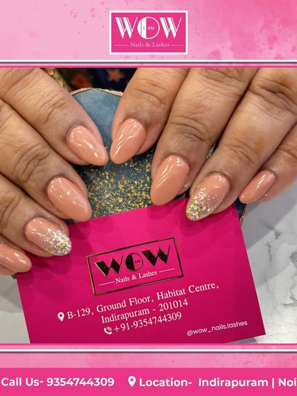 A chic combination of nude polish and a sparkling silver glitter accent nail. This look on almond-shaped nails is a great way to add some glam to a classic manicure.