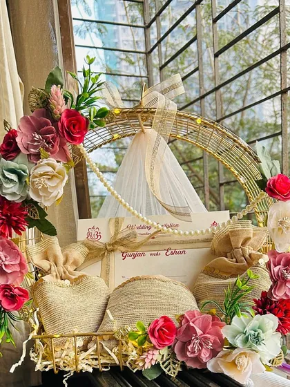 This is what first impressions are all about. I designed this wedding invitation hamper to be a breathtaking floral announcement, combining the formal invite with sweet treats in jute potlis, setting a tone of luxury and warmth for the celebrations ahead.