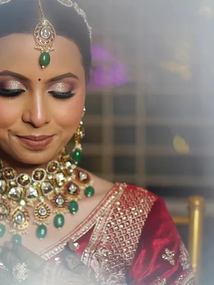 A beautiful close-up with eyes closed, showcasing the flawless glittery eyeshadow that adds a touch of glamour to her bridal look.