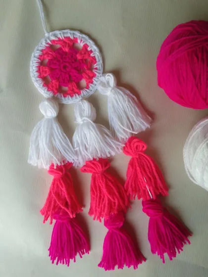A pink and white tassel dreamcatcher in the making.