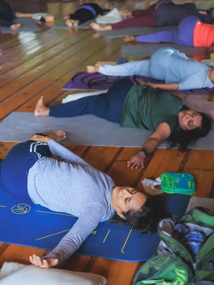 Students resting in a gentle spinal twist. Twists are excellent for releasing tension in the back and improving digestion.