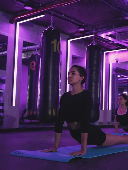 Find your focus in our group yoga sessions at The Lab. The mood lighting helps create a calming atmosphere as you move through poses like the upward-facing dog, building flexibility and strength.