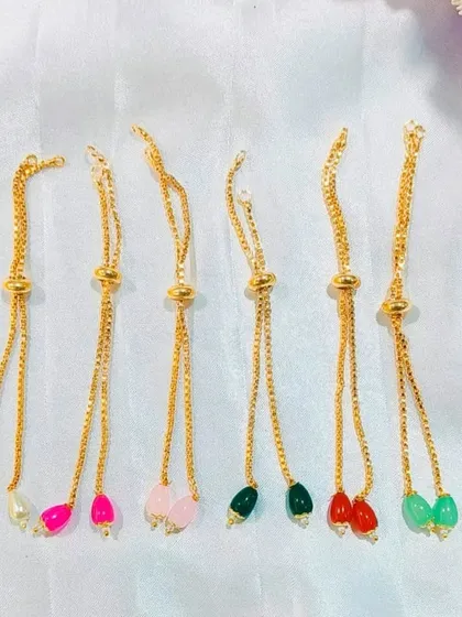 These adjustable slider chains with colorful beads are a modern and convenient option for Rakhi making. They are easy to wear and fit any wrist size.