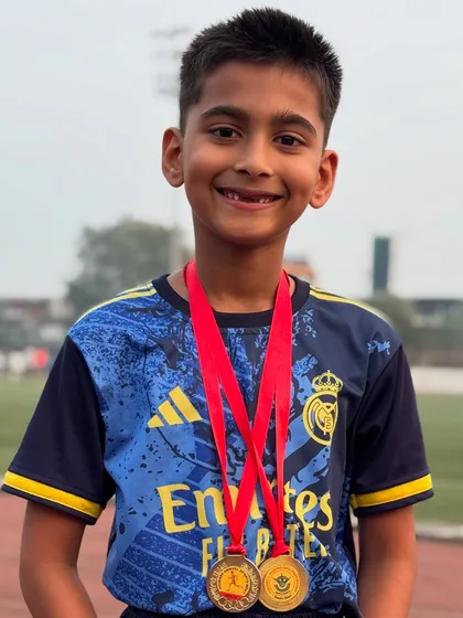 A brilliant smile from our athlete Parth, showing off the two Gold medals he won at his annual sports day. Pure happiness and achievement.