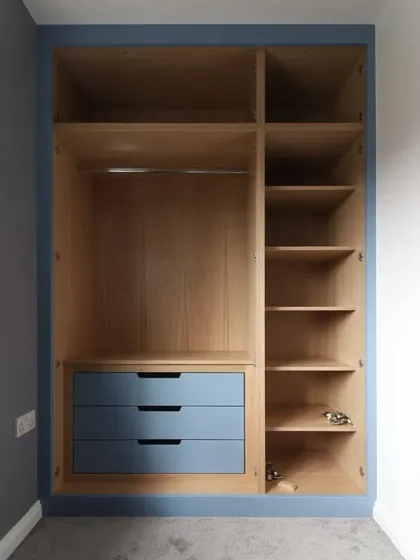 Here's a look inside one of our custom-built wardrobes. We design interiors for maximum utility, with a combination of hanging space, adjustable shelves, and drawers, ensuring every inch of your storage is functional and tailored to your needs.