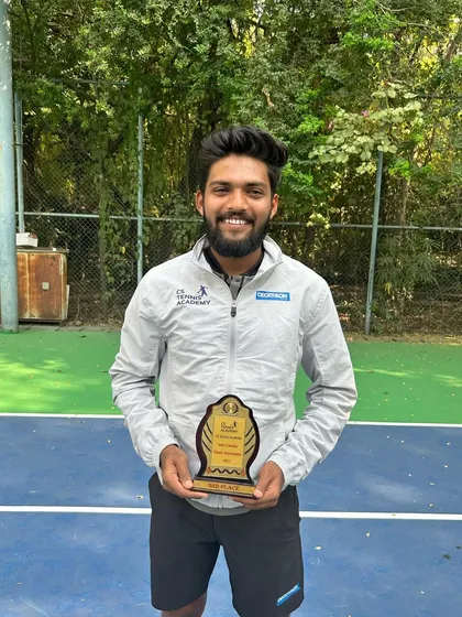 One of our coaches proudly holding his trophy from the internal tournament.