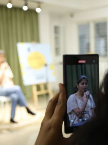 A member of the audience capturing the performance, a common sight at our engaging events.