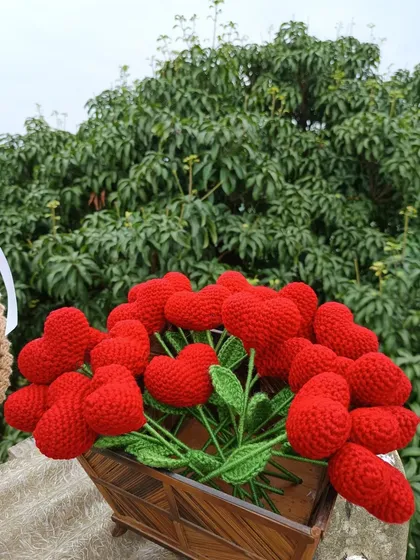 A basket overflowing with red heart flower stems, a basket full of love.