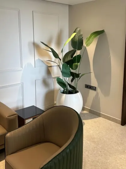 Another view of the artificial Bird of Paradise plant, showing how it fits perfectly into the corner of this elegantly designed room.
