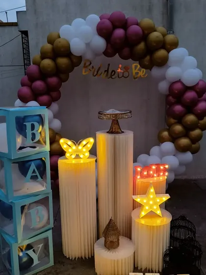 My circular backdrops are highly versatile for any celebration. This rooftop setup features a balloon arch in maroon, gold, and white, which can be used for a bridal shower, baby shower, or birthday, with props like the 'BABY' blocks easily swapped to fit your event theme.