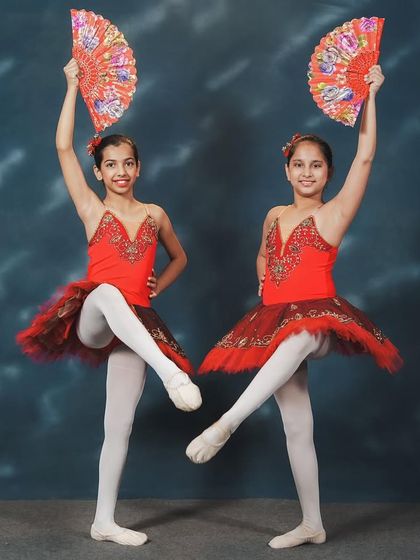 Presenting a piece from the classic ballet, "Don Quixote." Our dancers, in vibrant red tutus and holding fans, capture the Spanish flair of this famous repertoire. Our goal is to introduce students to iconic pieces from dance history and give them the chance to perform them on stage.