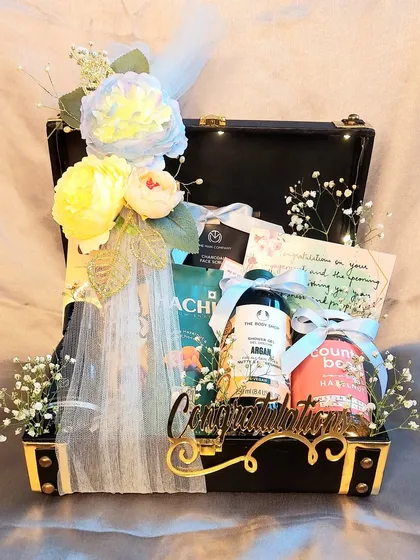 A sophisticated gift hamper for the Groom To Be. This black trunk is filled with premium grooming products, snacks, and a personal note to congratulate him on the new beginning.