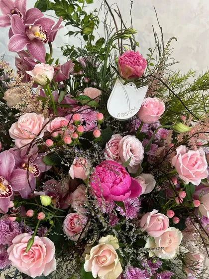 Delivering flowers that are soft, sweet, and juicy. This arrangement is a beautiful mix of pink peonies, astilbe, berries, cymbidiums, and roses, a true celebration of pink.