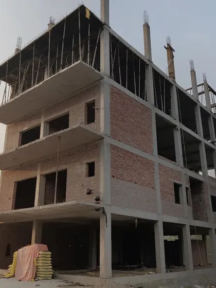 The structural frame of a residential building, showing the progress from the foundation to the upper floors.