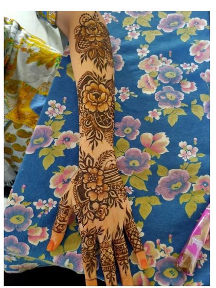 A full-arm floral design that looks like a beautiful sleeve of henna.