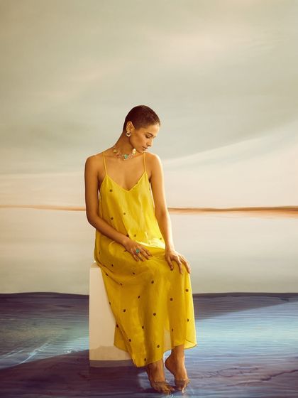 A simple, elegant look with a yellow slip dress. The minimal styling puts the focus entirely on the beautiful statement jewelry from Voyce.