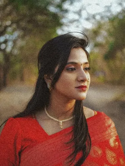 A thoughtful side-profile portrait with a grainy, vintage texture, capturing a quiet moment in nature.