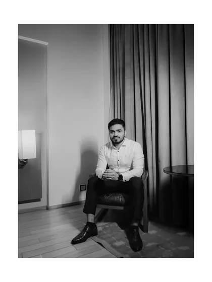 Groom portraiture is about capturing quiet confidence and style. This black and white photograph, taken indoors, uses soft, natural window light for a classic, sophisticated look. It’s a candid moment that feels both personal and polished, perfect for any groom's album.
