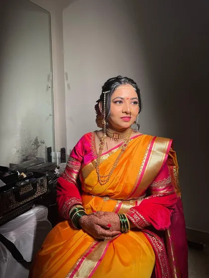 Another angle of Neha's classic Maharashtrian bridal look, with dramatic lighting highlighting the flawless makeup.