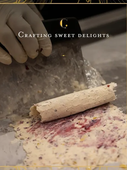 The art of dessert making is a craft we cherish. This action shot shows the creation of our signature Mishti Malai, where creamy, frozen goodness is hand-rolled with fresh ingredients, demonstrating our commitment to handcrafted quality.