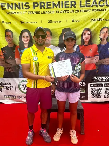 Eshanya Khattar celebrates winning her first Tennis Premier League singles final. She is pictured here on the red carpet in front of the official TPL banner.