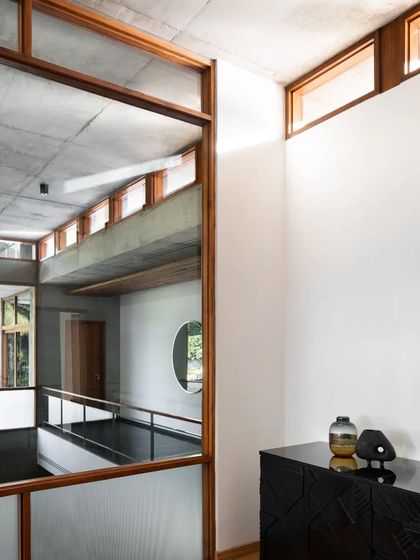 Reflections and views across the different levels of the 'House of Canopies'. The design uses glass and open corridors to create visual connections and a sense of a single, unified volume.