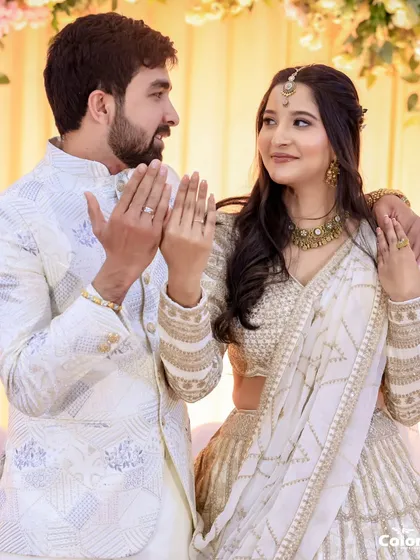 A playful moment between the newly engaged couple as they show off their rings.