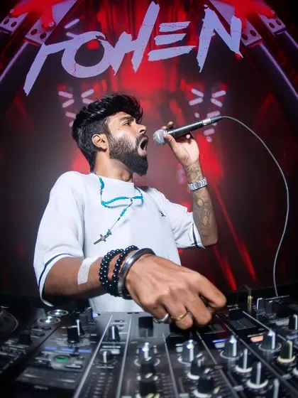 On the mic is where I feel most at home. It's my direct line to the crowd's energy, allowing me to hype everyone up and create a shared experience. This shot captures the essence of my 'Mic Raja' persona during a high-energy set.
