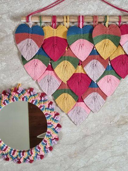 Let your true colors shine bright. This vibrant set, featuring a rainbow leaf hanging and a matching rainbow mirror, embraces a bold and beautiful palette.