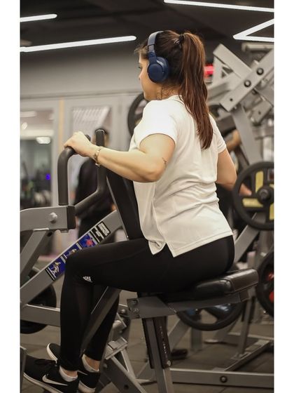 A member works her back on the seated row machine, demonstrating the consistency that leads to real results.