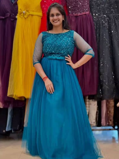 This vibrant teal blue gown is both elegant and fun. The sequined bodice adds sparkle, while the flowing tulle skirt is comfortable enough to dance the night away in.